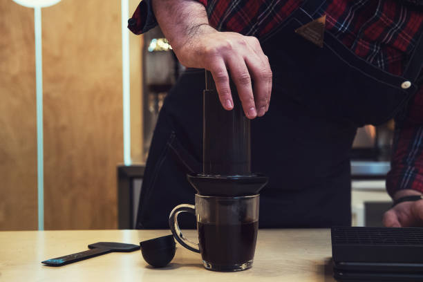 Barista brewing aeropress coffee