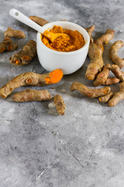 istock Turmeric root and ground turmeric. White bowl, gray background. 840923496