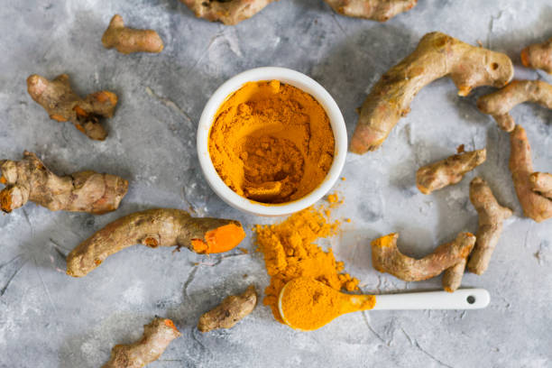 istock Turmeric root and ground turmeric. White bowl, gray background. 840923606