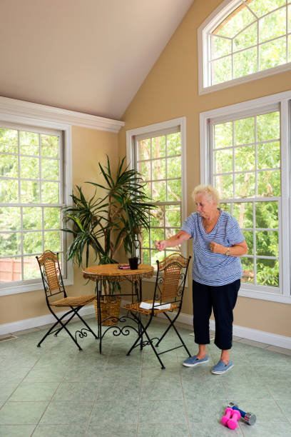 istock Senior doing physical therapy exercises at home 840923850