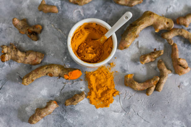 istock Turmeric root and ground turmeric. White bowl, gray background. 840923856