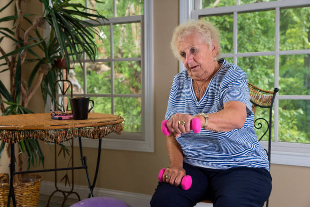 istock Senior doing physical therapy exercises at home 840923874