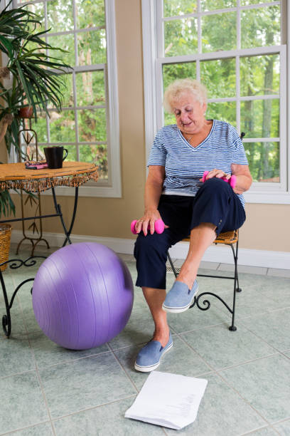 istock Senior doing physical therapy exercises at home 840923906