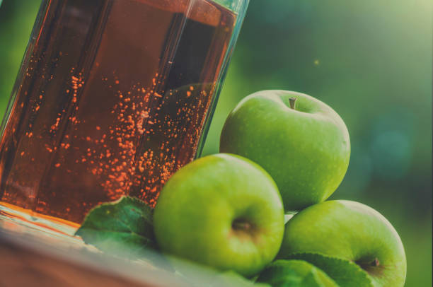 Pitcher of Apple Juice and green apples