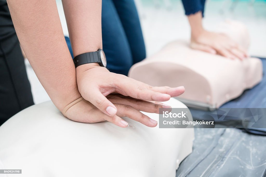 Nursing students are learning how to rescue the patient in emergency. CPR training with CPR doll. Closed-up. Soft focus. First Aid Class Stock Photo