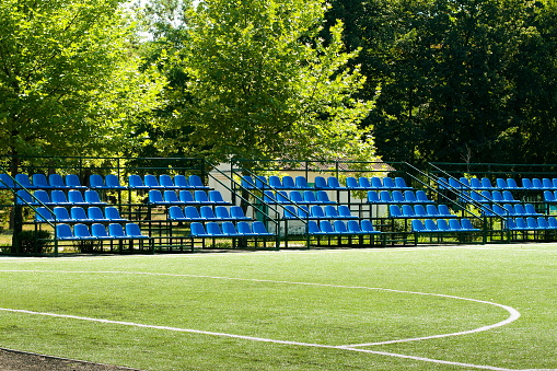 White benches outside the soccer field fence