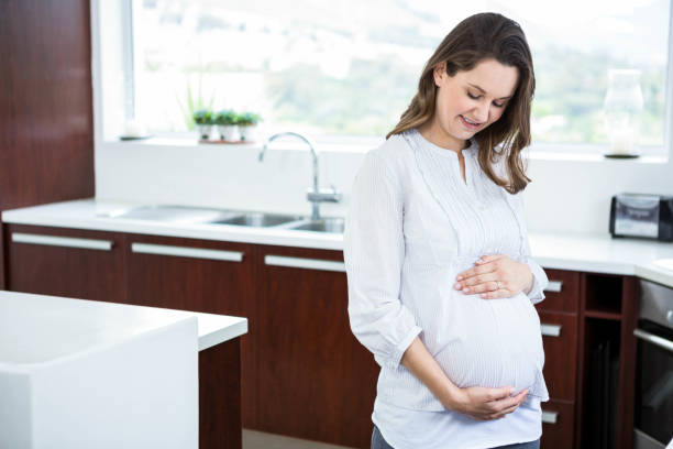 istock Pregnant woman touching her belly 840929778