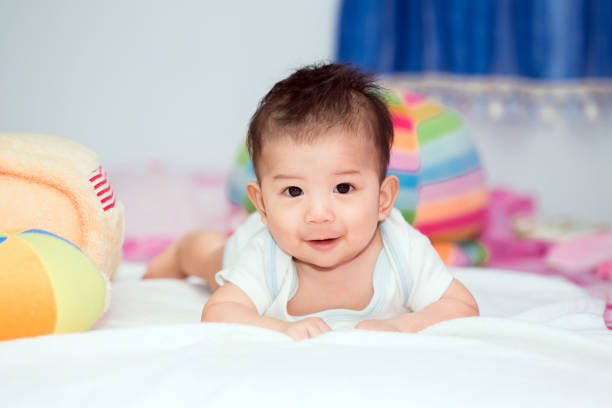 istock Cute baby in bed smiling and looking at camera. 840930690
