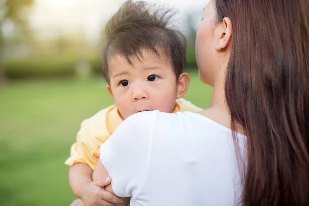 istock Young mother relaxing with her little son in spring garden. 840936072