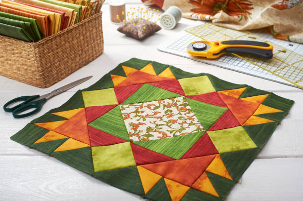 istock Patchwork orange-green block, quilting fabrics, sewing accessories 840939814