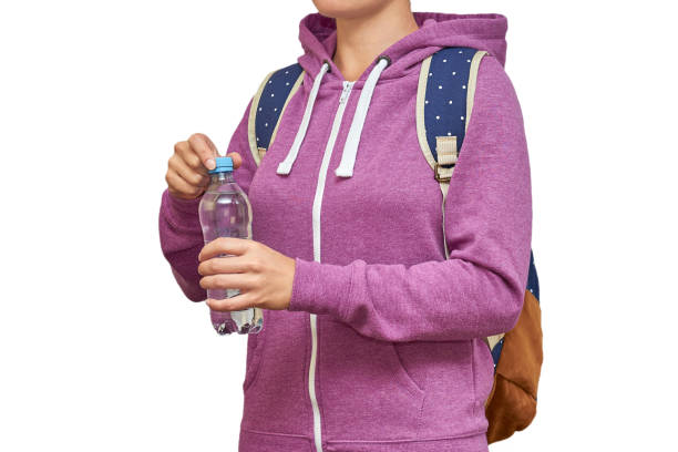 istock Girl with a backpack on her shoulders and water in her hands. isolated on white background 840943178