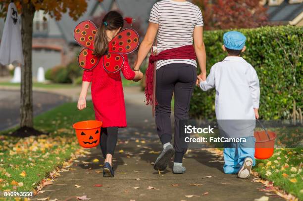 Two Children In Halloween Costumes Trick Or Treating Stock Photo - Download Image Now