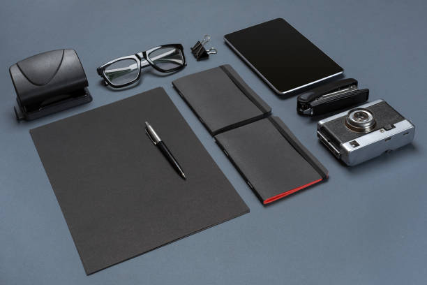 istock A set of black office accessories, glasses, old camera and tablet on gray background 840944832