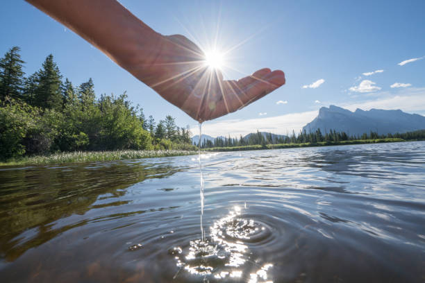istock Human hand cupped to catch fresh water from mountain lake 840947786