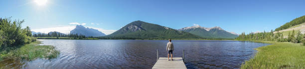 Young man contemplating nature by the lake