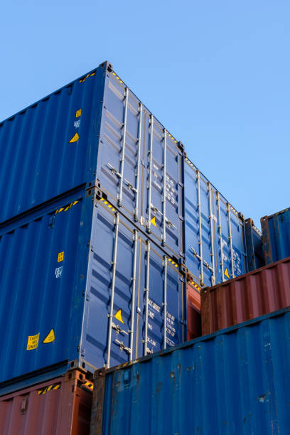 istock Low angle view of three layers of containers stacked in a shipping yard 840948102