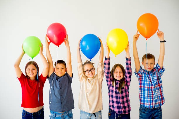istock Happy children with balloons 840948676
