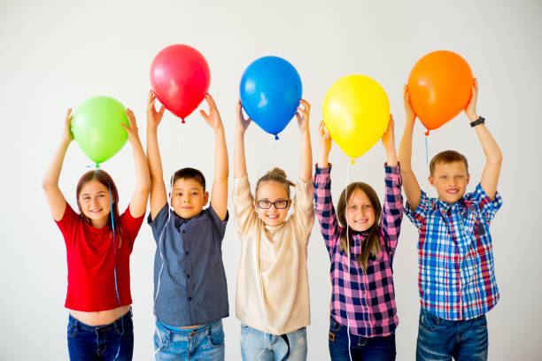 istock Happy children with balloons 840948736