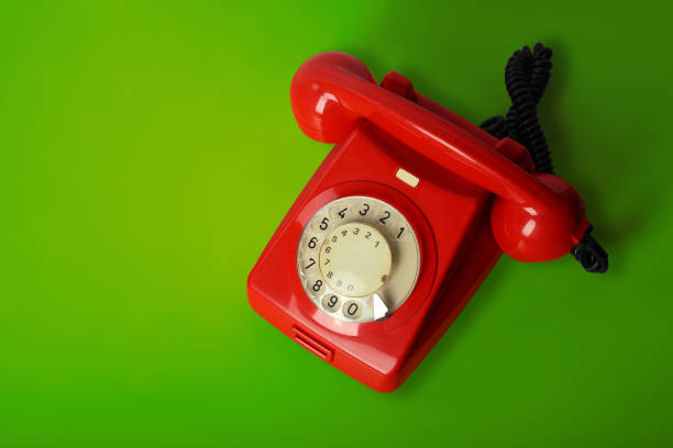 istock Red vintage phone on a green background 840950006