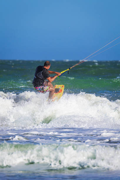 istock Young atletic man riding kite surf on a sea 840957310