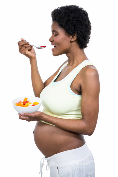 istock Pregnant woman eating fruit salad 840959508