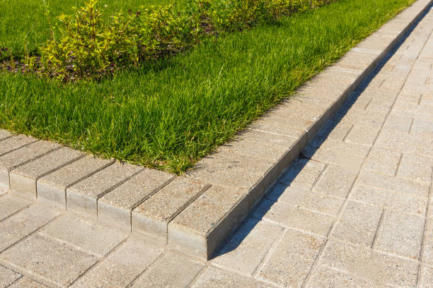 istock road and lawn divided by a concrete curb 840960826