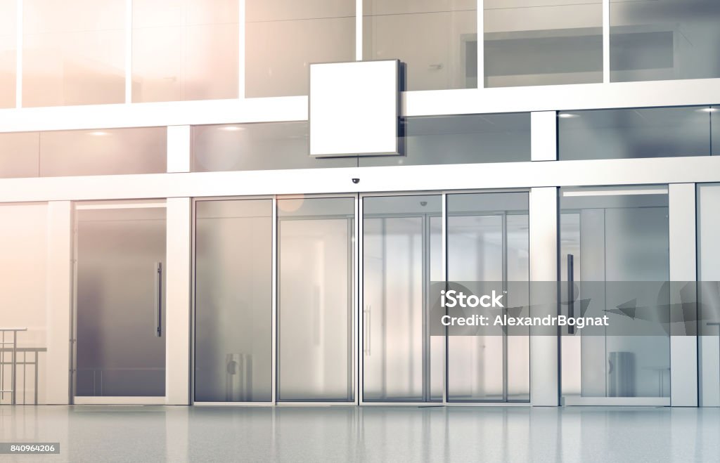 Blank white square signage mockup on store glass sliding doors Blank white square signage mockup on the store glass sliding doors entrance, 3d rendering. Commercial building automatic entry, banner mock up. Closed transparent business centre facade, front view. Door Stock Photo