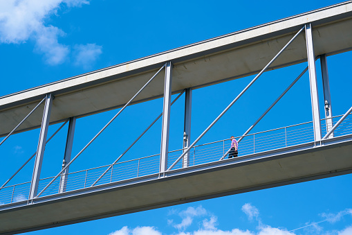 Man on a bridge (Marie-Elisabeth-Lüders-Bridge) between two government buildings in the government quarter in Berlin