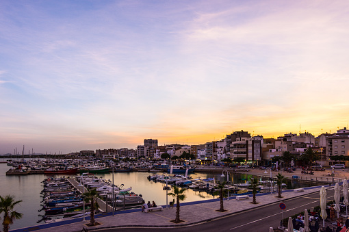 Sunset or golden hour in quiet port of l'Ampolla, Delta del Ebro in Spain. Mediterranean Sea