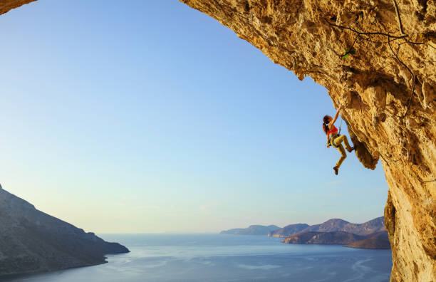 istock Young woman climbing challenging route in cave 840971306