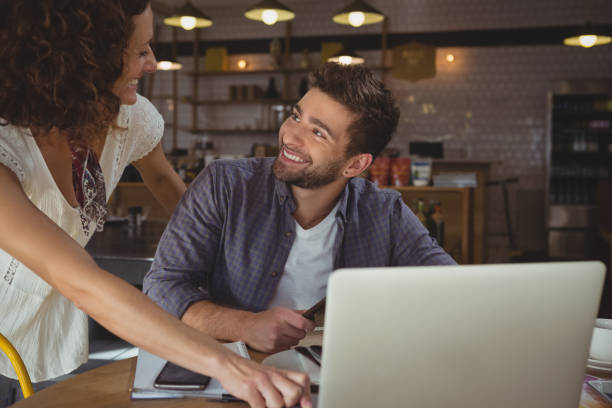 istock Happy business people looking each other in cafe 840971344