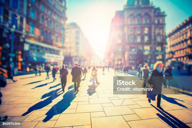 Crowd Of Anonymous People Walking On Sunset In The City Streets Stock Photo - Download Image Now