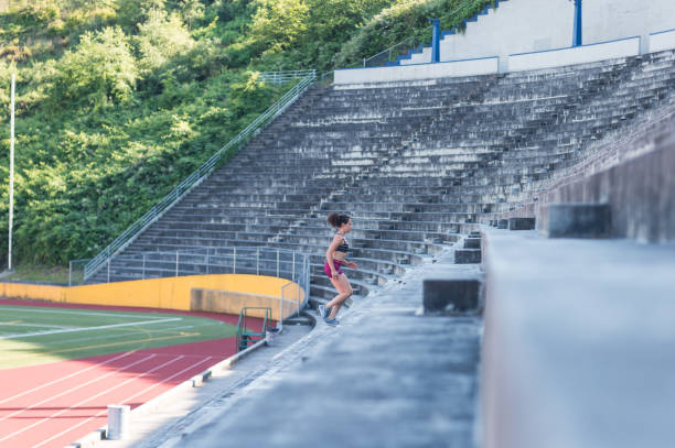 istock Female athlete working out at stadium field 840974348