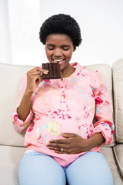 istock Pregnant woman eating chocolate 840979666
