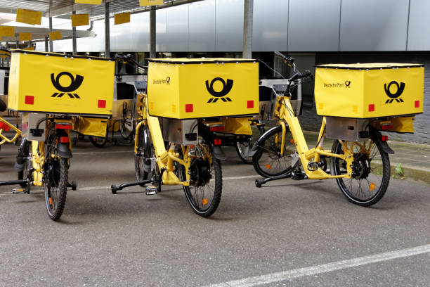 three german post bicycles - deutsche post ag package germany occupation imagens e fotografias de stock
