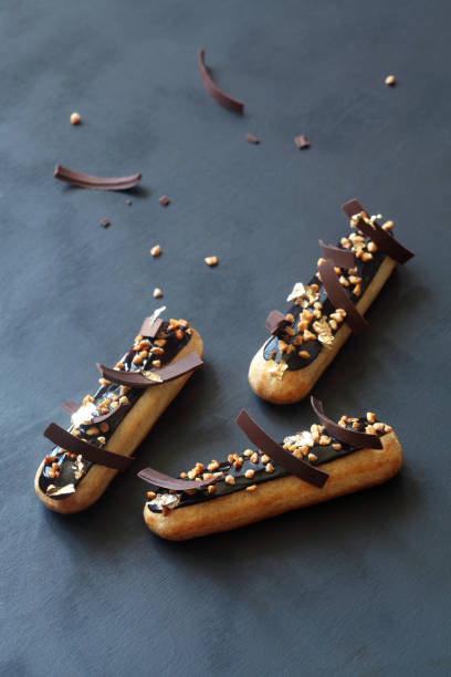 Chocolate eclairs with calamelized nuts stock photo