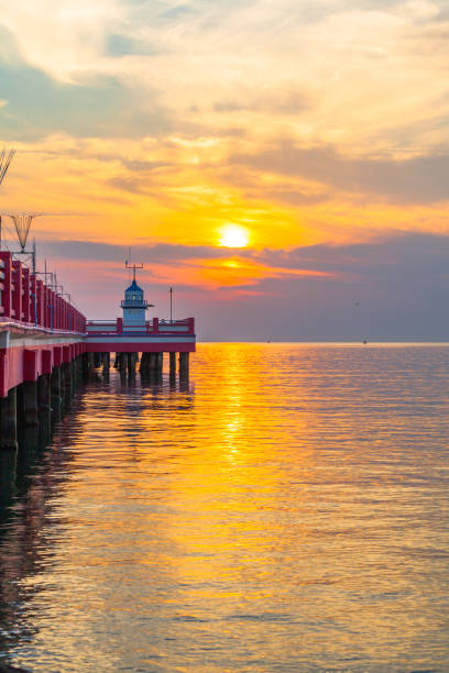istock golden sky above light house. 840985568