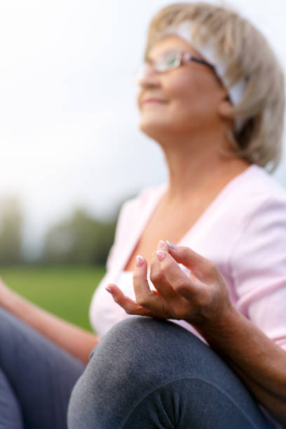 istock Hands of mature woman practicing yoga 840986064