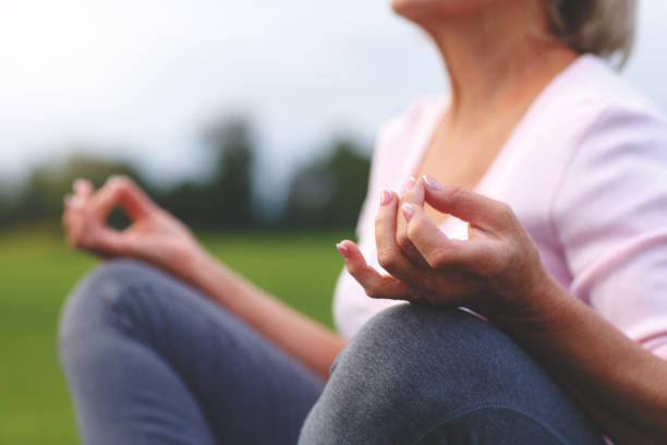 istock Hands of mature woman practicing yoga 840986088