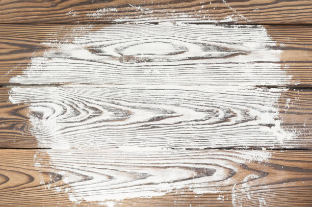istock Scattered white flour on old rustic wooden planks 840990546