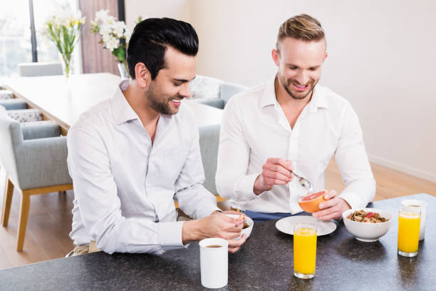 istock Smiling gay couple having breakfast 840990558