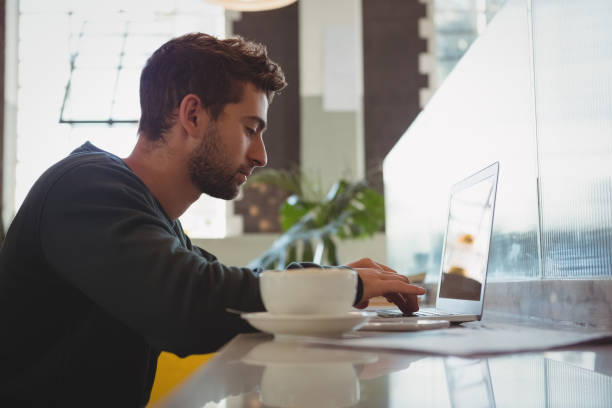 istock Businessman using laptop at cafe 840998012