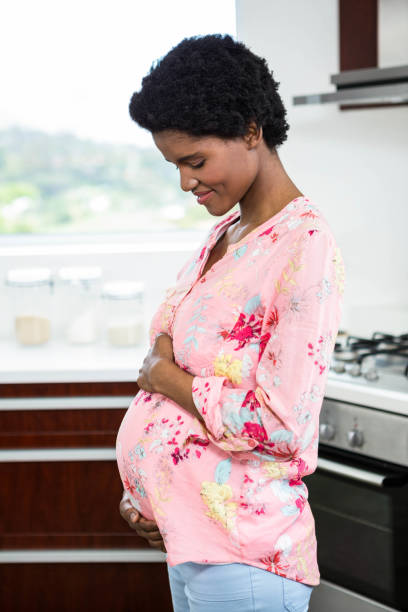 istock Pregnant woman touching belly 841001496
