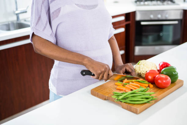 istock Pregnant woman preparing vegetables 841001514