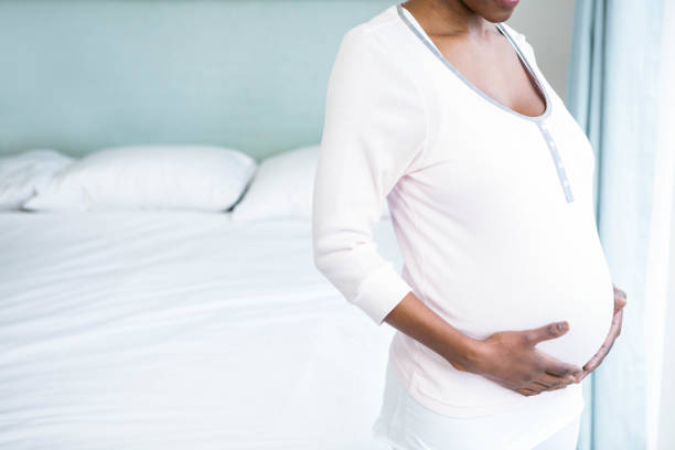 istock Pregnant woman touching her belly 841001702