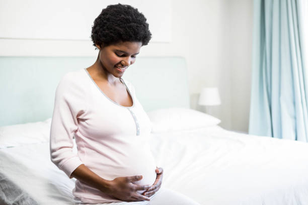 istock Pregnant woman touching her belly 841001856