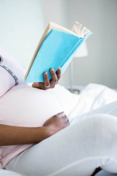 istock Pregnant woman reading a book 841002006