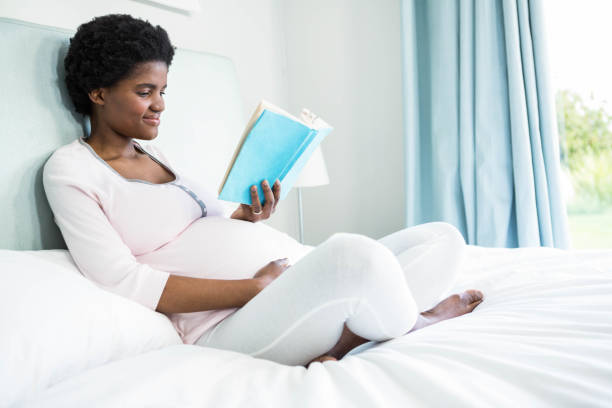 istock Pregnant woman reading a book 841002020