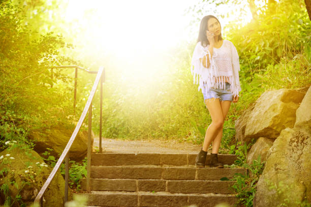 istock Woman using phone, park in Stockholm sunset 841002128