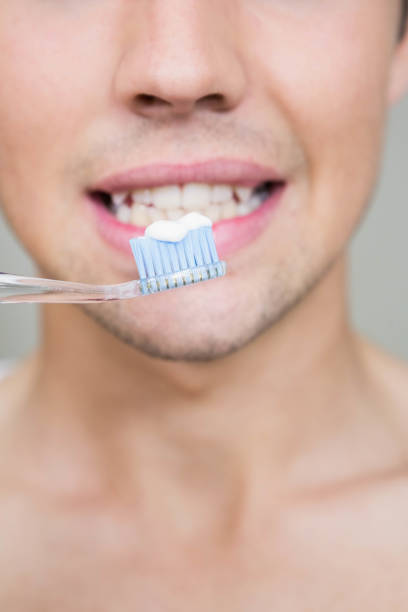 istock Close-up of man brushing teeth 841002498